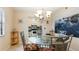 Bright dining room with unique chandelier and seating for four, next to the kitchen at 6100 Gulfport S Blvd # 415, Gulfport, FL 33707