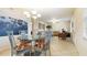 A well lit dining room features a glass top table, four upholstered chairs, and a decorative chandelier at 6100 Gulfport S Blvd # 415, Gulfport, FL 33707