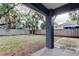 View of the backyard with a covered patio and wood fence, providing privacy for outdoor enjoyment at 6145 103Rd N Ave, Pinellas Park, FL 33782