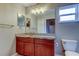 Bathroom boasts granite countertops, wood vanity, and decorative mirrors at 6145 103Rd N Ave, Pinellas Park, FL 33782
