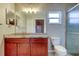 Bathroom boasts granite countertops, wood vanity, and decorative lighting at 6145 103Rd N Ave, Pinellas Park, FL 33782
