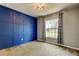 Bedroom featuring a blue accent wall with wall trim, neutral walls, carpet and a window with curtains at 6145 103Rd N Ave, Pinellas Park, FL 33782