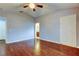 An airy bedroom with hardwood floors leads to ensuite bathroom and closet at 6145 103Rd N Ave, Pinellas Park, FL 33782