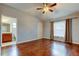 An airy bedroom features hardwood floors and a view into an ensuite bathroom at 6145 103Rd N Ave, Pinellas Park, FL 33782