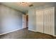 Bedroom featuring light-blue walls, carpet, a closet with doors and an open doorway at 6145 103Rd N Ave, Pinellas Park, FL 33782