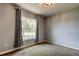 Bedroom featuring gray walls, carpet and a window with patterned curtains and view to the street at 6145 103Rd N Ave, Pinellas Park, FL 33782