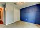 Bedroom featuring a blue accent wall with wall trim, carpet, and closet with doors at 6145 103Rd N Ave, Pinellas Park, FL 33782