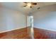 A bright bedroom with hardwood floors gives way to hall and ensuite bath at 6145 103Rd N Ave, Pinellas Park, FL 33782