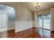 Bright dining room with hardwood floors and sliding glass doors to the backyard at 6145 103Rd N Ave, Pinellas Park, FL 33782