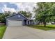 Charming one-story home featuring a spacious driveway, garage, and manicured lawn at 6145 103Rd N Ave, Pinellas Park, FL 33782