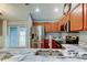 Modern kitchen featuring stainless steel appliances, marble countertops, and wood cabinets at 6145 103Rd N Ave, Pinellas Park, FL 33782