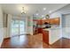 Modern kitchen area with stainless appliances, bar seating, and sliding door to backyard at 6145 103Rd N Ave, Pinellas Park, FL 33782