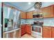 Updated kitchen features stainless steel appliances and warm wood cabinets at 6145 103Rd N Ave, Pinellas Park, FL 33782