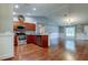 Open kitchen and living room with stainless steel appliances and wood floors at 6145 103Rd N Ave, Pinellas Park, FL 33782