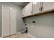 The laundry room features white cabinets, neutral walls and tile flooring at 6145 103Rd N Ave, Pinellas Park, FL 33782