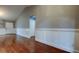 Spacious living room with wood floors, wainscotting, and neutral paint at 6145 103Rd N Ave, Pinellas Park, FL 33782