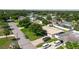 A neighborhood aerial view showcases this single-Gathering home with a large lawn, mature landscaping, and a brick driveway at 6573 20Th N St, St Petersburg, FL 33702