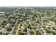 An aerial view reveals a residential neighborhood filled with mature trees, interspersed with serene lakes and bodies of water at 6573 20Th N St, St Petersburg, FL 33702