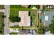 An aerial view shows a single-story home with well-maintained lawn and perimeter fence, with a neighboring pool and patio at 6573 20Th N St, St Petersburg, FL 33702