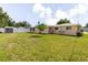 Backyard with a shed, privacy fence, and lush green lawn at 6573 20Th N St, St Petersburg, FL 33702