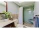 Bathroom featuring tiled shower with built in bench, and a bright vanity at 6573 20Th N St, St Petersburg, FL 33702