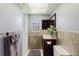 Bright bathroom featuring a vanity with a large mirror, tiled accents, and a skylight for natural lighting at 6573 20Th N St, St Petersburg, FL 33702