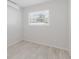 Clean and bright bedroom with wood-look floors, a window for natural light, and fresh white paint at 6573 20Th N St, St Petersburg, FL 33702