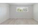 Bedroom featuring modern flooring, and closet space with bright window light at 6573 20Th N St, St Petersburg, FL 33702