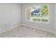Bright bedroom with tile floors and a large window overlooking the front yard at 6573 20Th N St, St Petersburg, FL 33702