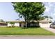 Beautiful one-story house with white brick, large front yard and mature tree coverage with an attached garage at 6573 20Th N St, St Petersburg, FL 33702