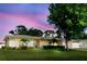 Charming home boasts lush green lawn, mature landscaping, and a welcoming facade at 6573 20Th N St, St Petersburg, FL 33702