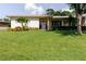 Lovely front yard showcases a pristine lawn, colorful flowers, and manicured shrubs at 6573 20Th N St, St Petersburg, FL 33702