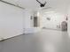 Open garage with epoxy floors, bright lighting, and an automatic door opener system installed overhead at 6573 20Th N St, St Petersburg, FL 33702