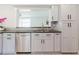 Well-lit kitchen showcasing gray cabinetry, stainless steel appliances, and a granite countertop at 6573 20Th N St, St Petersburg, FL 33702