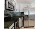Modern kitchen featuring gray cabinets, stainless steel appliances, and granite countertops at 6573 20Th N St, St Petersburg, FL 33702