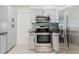Kitchen featuring gray cabinets, stainless steel appliances, and granite countertops at 6573 20Th N St, St Petersburg, FL 33702