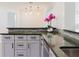 Modern kitchen with gray cabinets, granite countertops, and stainless steel appliances at 6573 20Th N St, St Petersburg, FL 33702