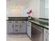 Well-lit kitchen with gray cabinets, granite countertops, and stainless steel appliances at 6573 20Th N St, St Petersburg, FL 33702