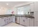 Modern kitchen featuring gray cabinetry, stainless steel appliances, and a stylish backsplash at 6573 20Th N St, St Petersburg, FL 33702