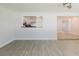 Bright living room with a view to the kitchen, ceiling fan, and stylish flooring at 6573 20Th N St, St Petersburg, FL 33702
