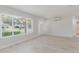 Bright living room with tile floors, large window, and neutral paint at 6573 20Th N St, St Petersburg, FL 33702
