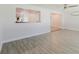 Bright living room with a view to the kitchen, ceiling fan, and stylish flooring at 6573 20Th N St, St Petersburg, FL 33702