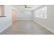 Bright living room with a view to the kitchen, ceiling fan, and stylish flooring at 6573 20Th N St, St Petersburg, FL 33702
