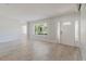 Spacious living room featuring beautiful light-colored floors, window and front door at 6573 20Th N St, St Petersburg, FL 33702