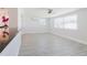 Bright living room with a view to the kitchen, ceiling fan, and stylish flooring at 6573 20Th N St, St Petersburg, FL 33702