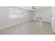 Spacious living room featuring tile floors, ceiling fan, and large window at 6573 20Th N St, St Petersburg, FL 33702