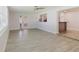 Bright living room with a view to the kitchen, ceiling fan, and stylish flooring at 6573 20Th N St, St Petersburg, FL 33702