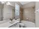 Bathroom featuring a white vanity, shower and tub combination, and a window for natural light at 7732 Bulls Head Dr, Wesley Chapel, FL 33545