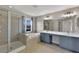 Bathroom with a glass enclosed shower, soaking tub and double vanity sinks at 7732 Bulls Head Dr, Wesley Chapel, FL 33545