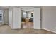 View from the bedroom, through the double doors into the bathroom with tub and glass shower enclosure at 7732 Bulls Head Dr, Wesley Chapel, FL 33545